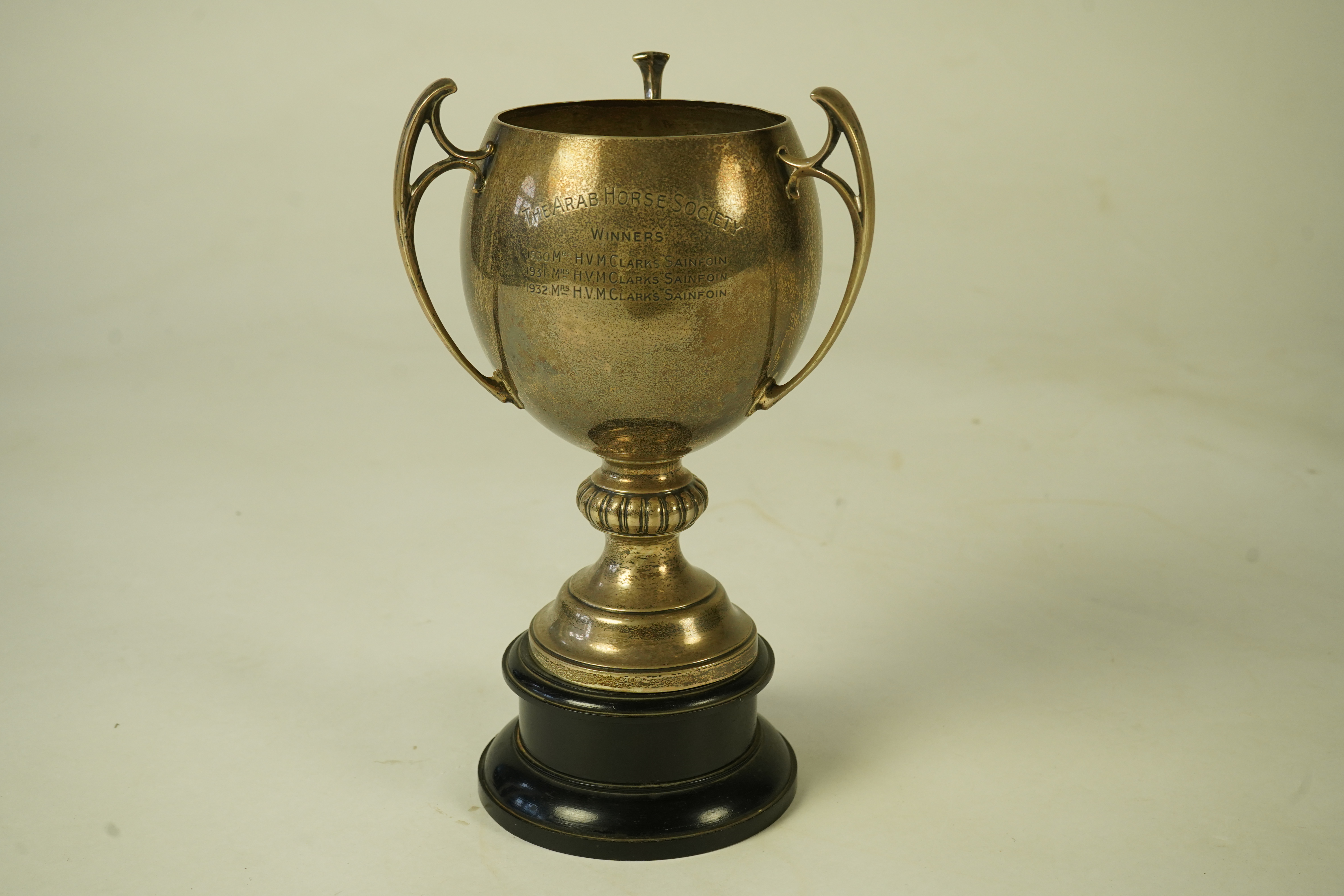 A George V silver tri-handled presentation pedestal trophy cup, with engraved horse racing inscription relating to 'The Arab Horse Society Challenge Cup for the Best Stallion or Colt'